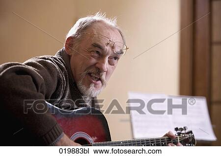 mature music instructor playing guitar View Large Photo Image Stock Image - mature music instructor playing guitar. Fotosearch