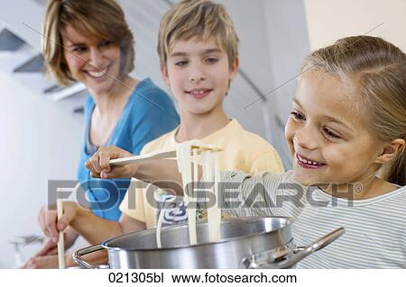 mother and brother watching young girl cooking spaghetti View Large Photo Image Stock Image - mother and brother watching young girl cooking spaghetti. Fotosearch