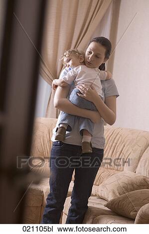 mother holding little son in her arms View Large Photo Image Stock Image - mother holding little son in her arms. Fotosearch