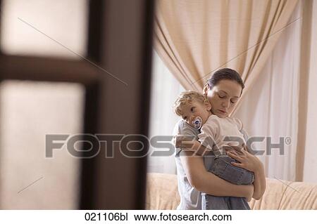 mother holding little son in her arms View Large Photo Image Stock Image - mother holding little son in her arms. Fotosearch