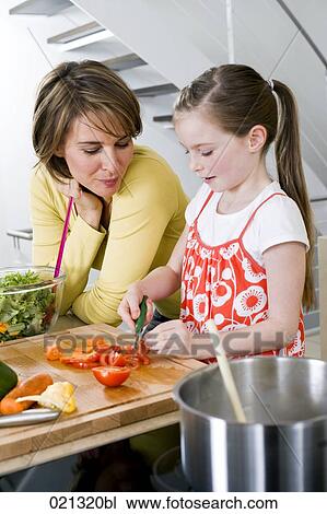 mother watching her daughter cutting vegetables View Large Photo Image Stock Image - mother watching her daughter cutting vegetables. Fotosearch