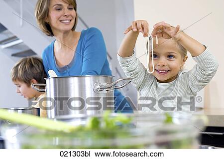 mother watching her daughter tasting spaghetti View Large Photo Image Stock Image - mother watching her daughter tasting spaghetti. Fotosearch