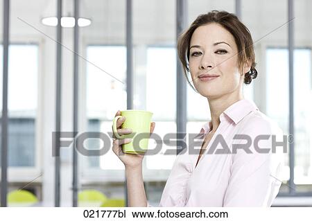 Stock Image - portrait of businesswoman holding mug. Fotosearch