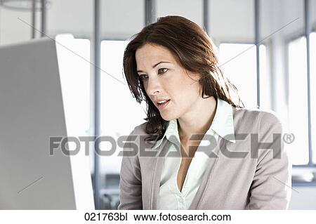 portrait of businesswoman looking at computer screen View Large Photo Image Stock Image - portrait of businesswoman looking at computer screen. Fotosearch