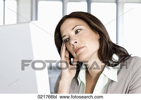 portrait of enervated businesswoman looking at computer screen View Large Photo Image Stock Image - portrait of enervated businesswoman looking at computer screen. Fotosearch