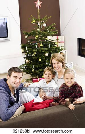 portrait of family in front of christmas tree View Large Photo Image Stock Image - portrait of family in front of christmas tree. Fotosearch
