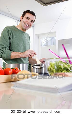 portrait of man cooking meal in kitchen View Large Photo Image Stock Image - portrait of man cooking meal in kitchen. Fotosearch