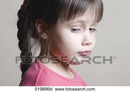Stock Image - portrait of suspicious young girl. Fotosearch