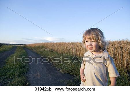 portrait of toddler in front of field View Large Photo Image Stock Image - portrait of toddler in front of field. Fotosearch
