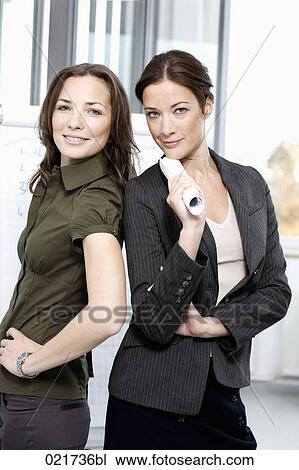 portrait of two businesswomen standing back to back View Large Photo Image Stock Image - portrait of two businesswomen standing back to back. Fotosearch