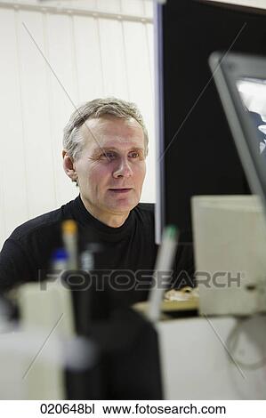 portrait of worker at computer repair shop looking at monitor View Large Photo Image Stock Image - portrait of worker at computer repair shop looking at monitor. Fotosearch