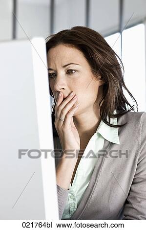 Stock Image - portrait of worried businesswoman looking at computer screen. Fotosearch