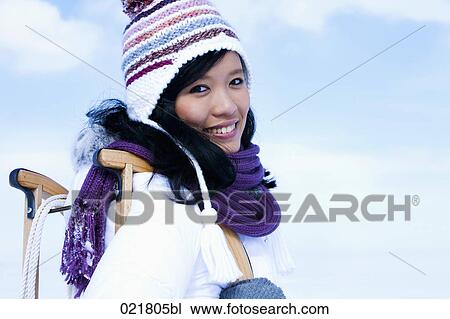 portrait of young asian woman in winter carrying sledge View Large Photo Image Stock Image - portrait of young asian woman in winter carrying sledge. Fotosearch