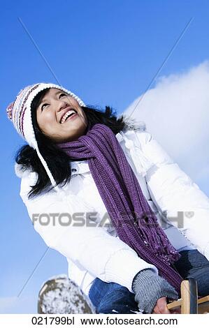 portrait of young asian woman sitting on sledge View Large Photo Image Stock Image - portrait of young asian woman sitting on sledge. Fotosearch