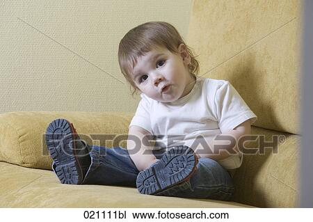 portrait of young boy sitting on sofa View Large Photo Image Stock Image - portrait of young boy sitting on sofa. Fotosearch