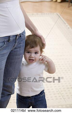 Stock Image - portrait of young boy standing beside his mother. Fotosearch