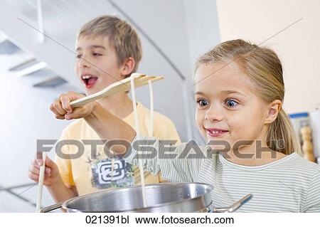 portrait of young girl cooking pasta View Large Photo Image Stock Image - portrait of young girl cooking pasta. Fotosearch