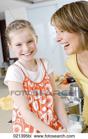 portrait of young girl drinking glass of milk in kitchen View Large Photo Image Stock Image - portrait of young girl drinking glass of milk in kitchen. Fotosearch