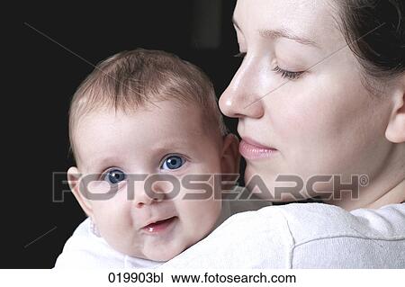 portrait of young mother holding her baby girl View Large Photo Image Stock Image - portrait of young mother holding her baby girl. Fotosearch