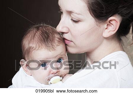 portrait of young mother holding her baby girl View Large Photo Image Stock Image - portrait of young mother holding her baby girl. Fotosearch