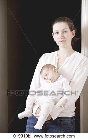 portrait of young mother holding her sleeping baby girl View Large Photo Image Stock Image - portrait of young mother holding her sleeping baby girl. Fotosearch