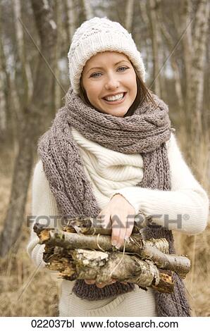 portrait of young woman in autumn carrying logs View Large Photo Image Stock Image - portrait of young woman in autumn carrying logs. Fotosearch