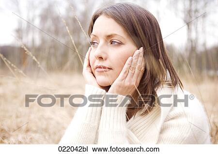 portrait of young woman in autumn sitting in grass View Large Photo Image Stock Image - portrait of young woman in autumn sitting in grass. Fotosearch