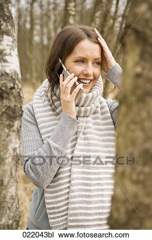 portrait of young woman in autumn talking on mobile phone View Large Photo Image Stock Image - portrait of young woman in autumn talking on mobile phone. Fotosearch
