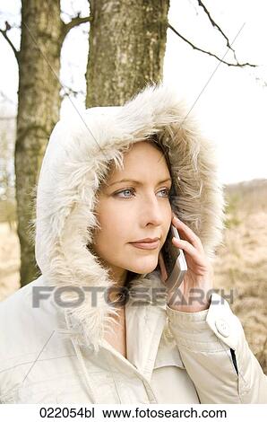portrait of young woman in autumn talking on mobile phone View Large Photo Image Stock Image - portrait of young woman in autumn talking on mobile phone. Fotosearch