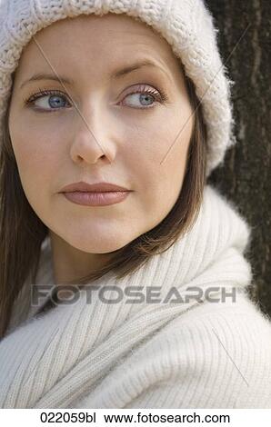portrait of young woman in autumn leaning against tree View Large Photo Image Stock Image - portrait of young woman in autumn leaning against tree. Fotosearch