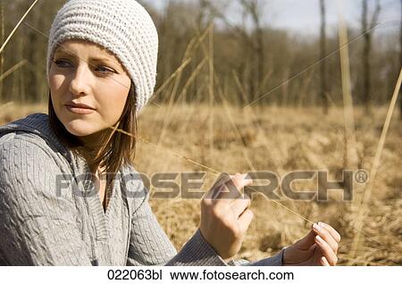 portrait of young woman in autumn sitting on meadow View Large Photo Image Stock Image - portrait of young woman in autumn sitting on meadow. Fotosearch