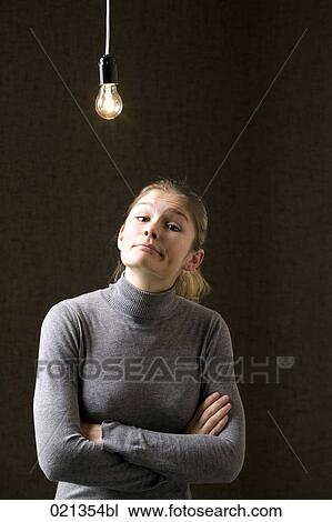 portrait of young woman under light bulb View Large Photo Image Stock Image - portrait of young woman under light bulb. Fotosearch