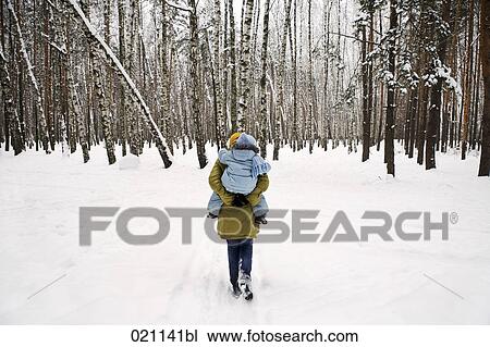 rear view of mother giving young daughter piggyback ride in winter forest View Large Photo Image Stock Image - rear view of mother giving young daughter piggyback ride in winter forest. Fotosearch