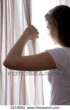 rear view of teenage girl looking through curtain View Large Photo Image Stock Image - rear view of teenage girl looking through curtain. Fotosearch