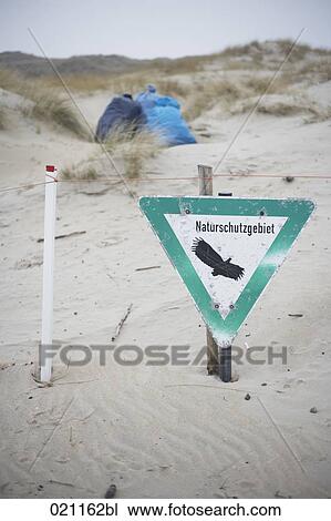 sign of nature reserve on sandy beach with sacks full of trash in background View Large Photo Image Stock Image - sign of nature reserve on sandy beach with sacks full of trash in background. Fotosearch