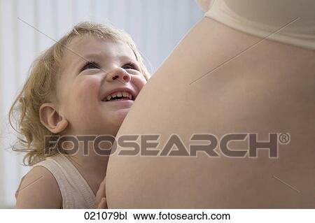 smiling young boy touching belly of pregnant mother View Large Photo Image Stock Image - smiling young boy touching belly of pregnant mother. Fotosearch