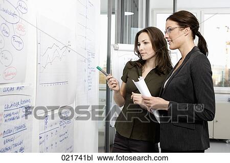 two businesswomen in front of whiteboard View Large Photo Image Stock Image - two businesswomen in front of whiteboard. Fotosearch