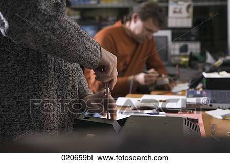 two workers at computer repair shop View Large Photo Image Stock Image - two workers at computer repair shop. Fotosearch