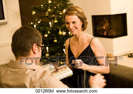 woman getting christmas present from man View Large Photo Image Stock Image - woman getting christmas present from man. Fotosearch
