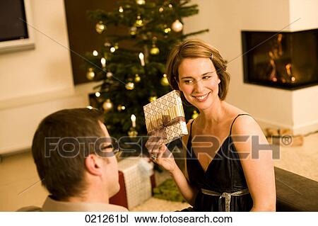 woman getting christmas present from man View Large Photo Image Stock Image - woman getting christmas present from man. Fotosearch