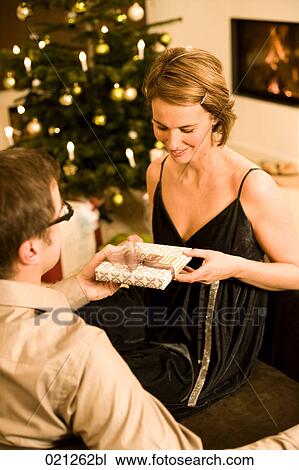 woman getting christmas present from man View Large Photo Image Stock Image - woman getting christmas present from man. Fotosearch