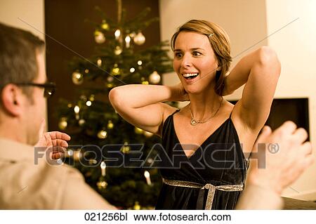 woman getting necklace as christmas present from man View Large Photo Image Stock Image - woman getting necklace as christmas present from man. Fotosearch