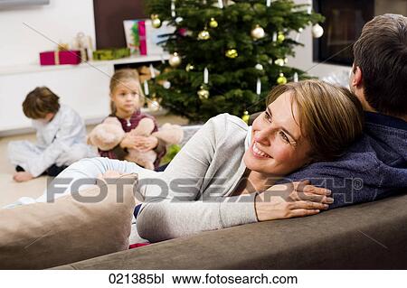 woman leaning on man on christmas morning View Large Photo Image Stock Image - woman leaning on man on christmas morning. Fotosearch