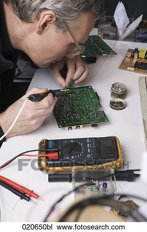 worker at computer repair shop soldering motherboard View Large Photo Image Stock Image - worker at computer repair shop soldering motherboard. Fotosearch