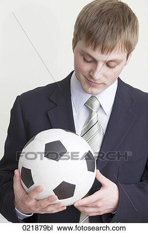 young businessman holding football View Large Photo Image Stock Image - young businessman holding football. Fotosearch