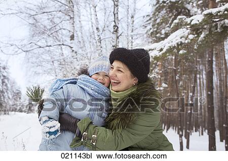 young girl and grandmother sharing a laugh in winter forest View Large Photo Image Stock Image - young girl and grandmother sharing a laugh in winter forest. Fotosearch