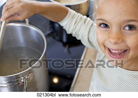 young girl cooking in kitchen View Large Photo Image Stock Image - young girl cooking in kitchen. Fotosearch