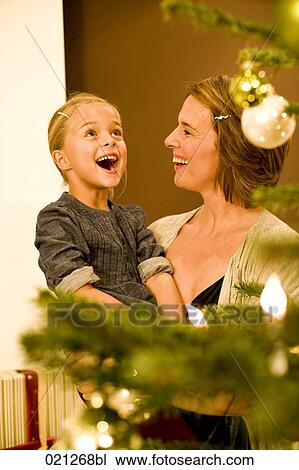 young girl looking at christmas tree View Large Photo Image Stock Image - young girl looking at christmas tree. Fotosearch