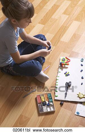 young girl playing with modelling clay View Large Photo Image Stock Image - young girl playing with modelling clay. Fotosearch