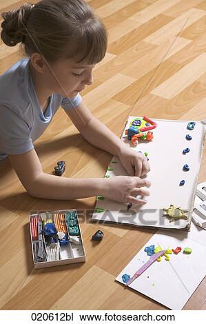 young girl playing with modelling clay View Large Photo Image Stock Image - young girl playing with modelling clay. Fotosearch